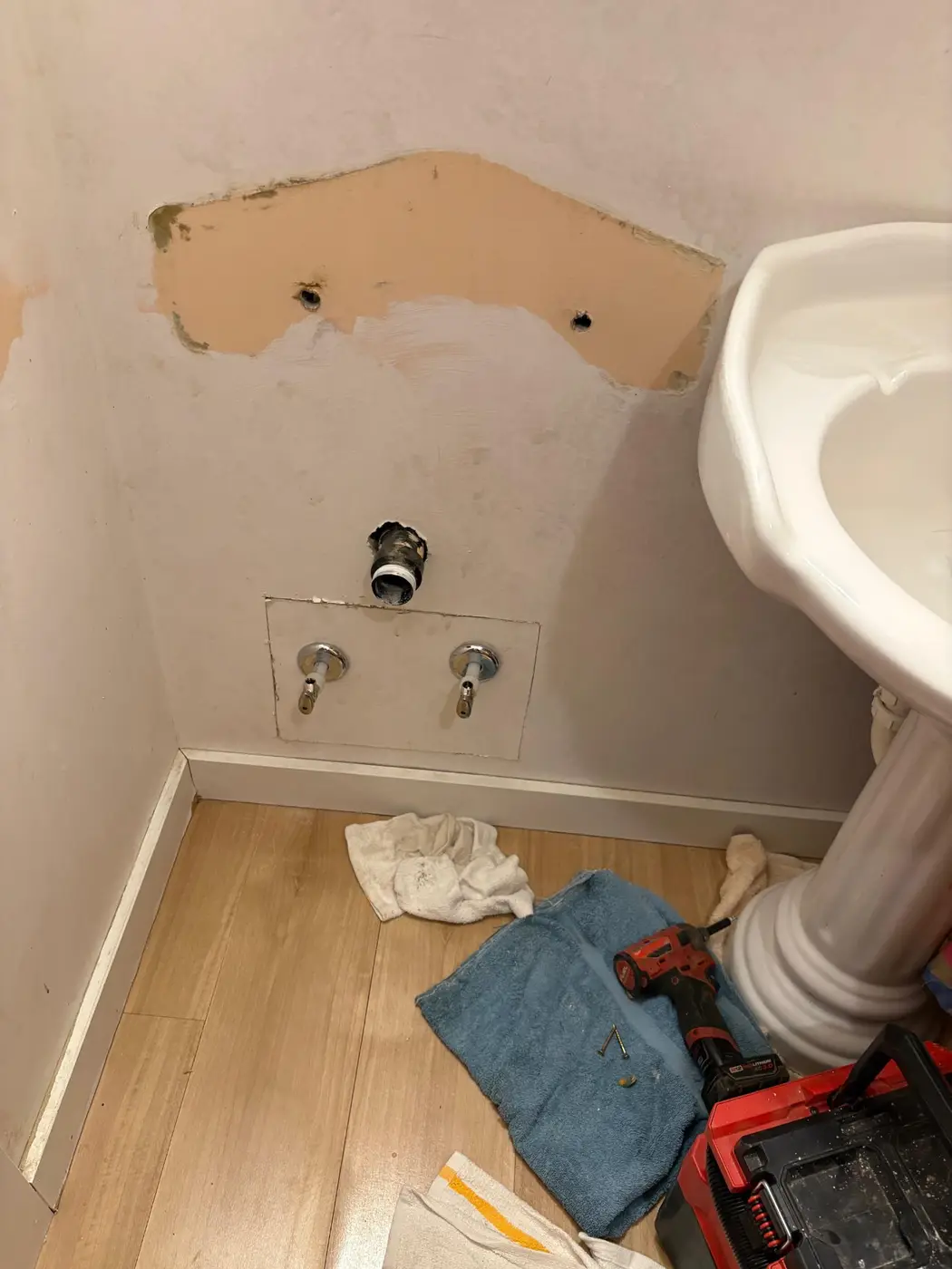 Pedestal sink rough-in and drywall repair by Wild Pine Plumbing in Portland, Oregon