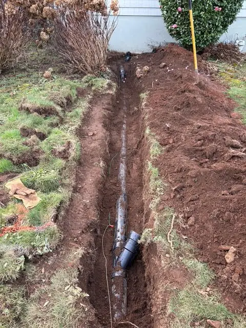 Long residential sewer line trench excavation and pipe lay by Wild Pine Plumbing in Portland, Oregon