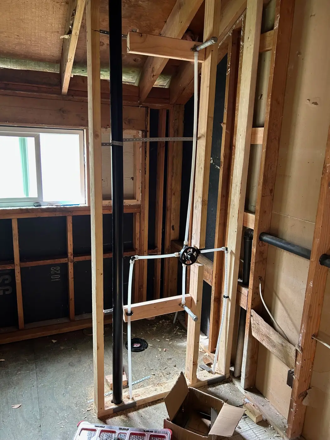 Shower valve rough-in with PEX supplies and ABS drain stack by Wild Pine Plumbing in St Helens, Oregon