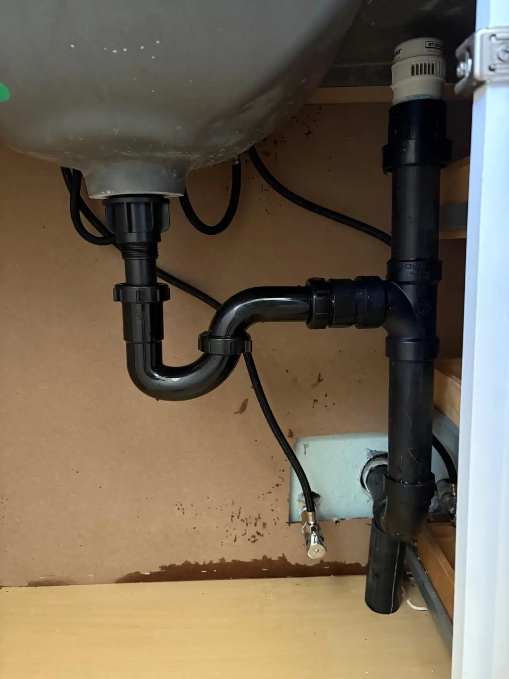 Under-sink ABS P-trap, drain, and air admittance valve install by Wild Pine Plumbing in Portland, Oregon