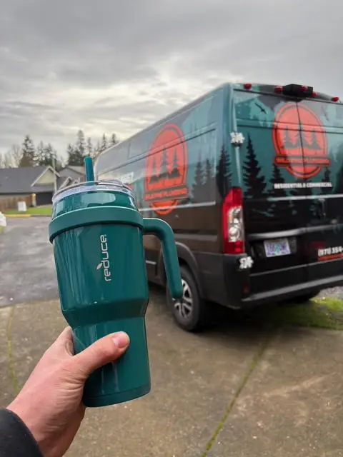 Wild Pine Plumbing branded service van parked at a residential job in St Helens, Oregon